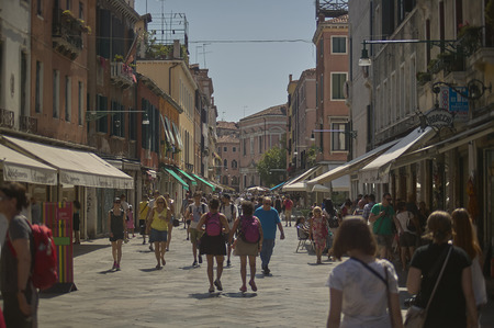 Tourists walking through the streets of venice during a summer day.のeditorial素材