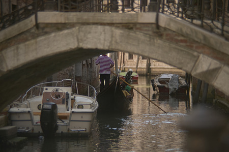 Channel with gondola and boats in venice, detail of navigation in Venice.の写真素材