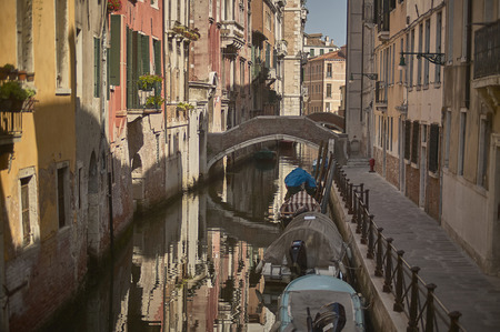 Small canal of Venice with bridge to pass it in a unique and evocative cityscape!の写真素材