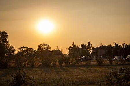 Rural landscape of northern italy resumed at sunset with red lightの写真素材