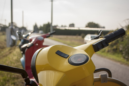 First-person photo of a yellow scooter, seeing how it is to drive a scooter.の写真素材