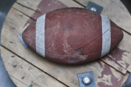 Detail of a vintage football ball with all the signs of time and wear.の写真素材