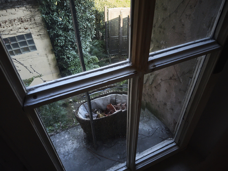 Detail of a vintage window shot against the light: a symbol of sadness, and the desire to get out of freedom.の写真素材
