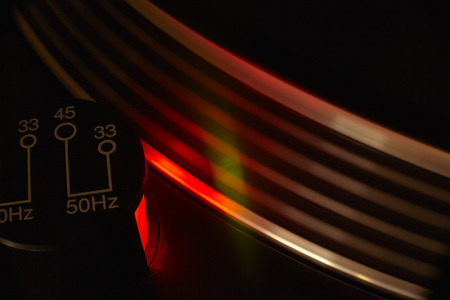 Detail of the plate of a vintage dj turntable with strobe light turned on for the evaluation of the time set up of the track. Moving plate.のeditorial素材