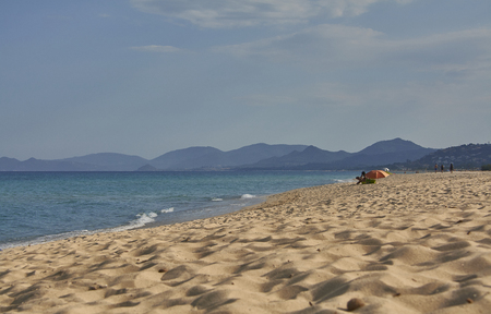 View of the oceanic beach with bathers under the umbrella that enjoy relaxation and peace and tranquility.の写真素材