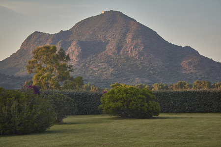 Enchanted meadow with behind a natural mountain immerson in the green of the local vegetation.の写真素材