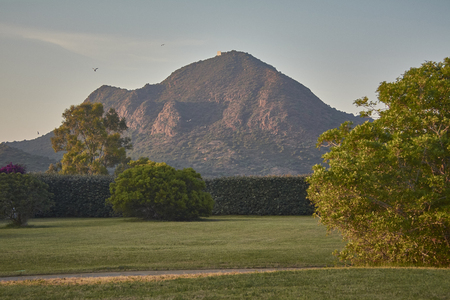 Enchanted meadow with behind a natural mountain immerson in the green of the local vegetation.の写真素材