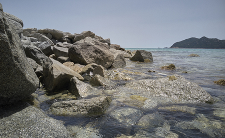 Detail of a cliff overlooking the transparent sea of Cala Sinzias beach in Sardinia.の写真素材