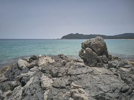 Detail of some rocks that protrude on the sea in a typical beach of southern Sardinia.の写真素材