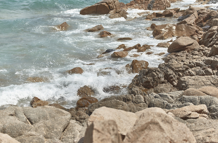 Detail of the sea waves crashing on the rocks creating splashes of water.の写真素材
