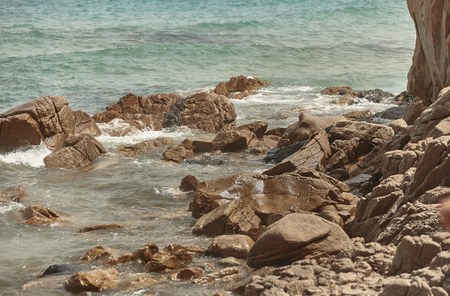 Detail of rocks and rocks coming out of the sea in a cliff south of Sardinia.の写真素材