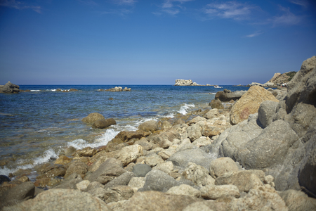 Detail of a cliff full of small and medium-sized stones that lies on the Mediterranean sea of southern Sardinia.の写真素材