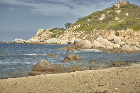 Rocks sprouting from the sea in the beautiful Mediterranean beach of Cala Sa Figu in the south of Sardinia.の写真素材