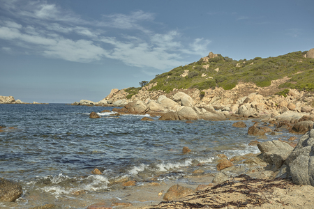 Detail of Cala Sa Figu beach in Sardinia with its typical rocks and hills rising above the sea.の写真素材