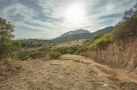 Land and rocks typical of the hilly landscape of the southern coast of Sardinia.の写真素材