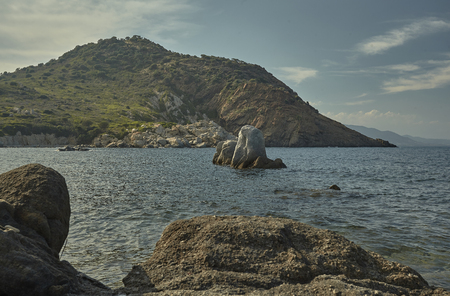 Wonderful rocky seascape with rock that rises from the sea in the Mediterranean beach of Cala Sa Figu in Sardinia.の写真素材