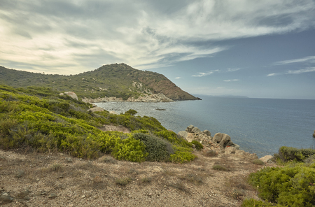 HDR shot of a beautiful Mediterranean bay typical of the southern coast of Sardinia in Italy during the sunset.の写真素材
