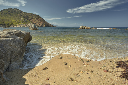 Magnificent postcard with a detail of a beautiful Mediterranean beach with the waves of the sea coming on the sand.の写真素材