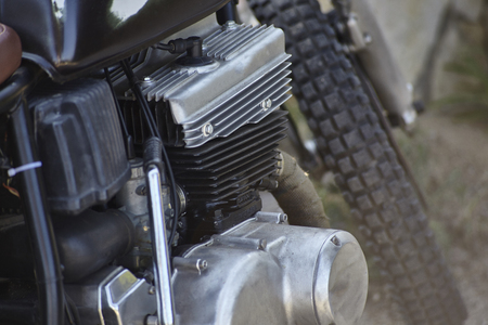 Detail of the head, the engine body, the crankcase, and other various mechanical components of a four-stroke petrol engine belonging to an old vintage motorcycle.の写真素材