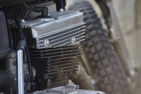 Detail of the head, the engine body, the crankcase, and other various mechanical components of a four-stroke petrol engine belonging to an old vintage motorcycle.の写真素材
