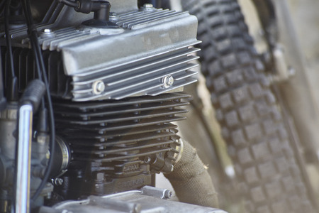 Detail of the head, the engine body, the crankcase, and other various mechanical components of a four-stroke petrol engine belonging to an old vintage motorcycle.の写真素材