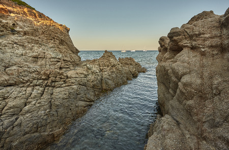 Cliff on the sea at sunset: typical view of the south coast of Sardinia.の写真素材
