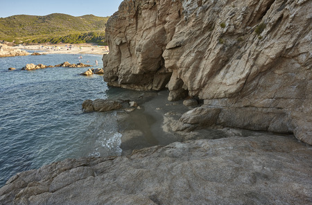 Natural cave carved on a rocky wall in the southern coast of Sardinia: Cala Sa Figu beach.の写真素材