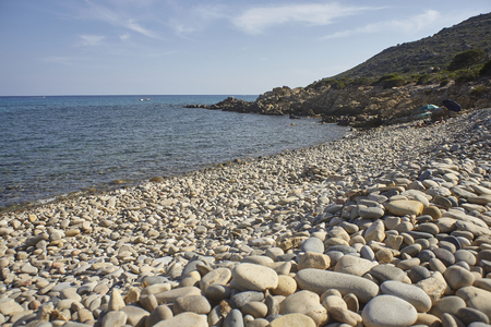 Punta Molentis beach in southern Sardinia: A white pebble beach surrounded by nature and a pristine landscape.の写真素材