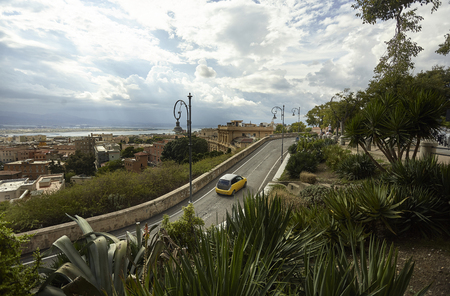 Aerial view of the historic center of Cagliari with clearly visible the various historical buildings, a small road that crosses the view with a car that runs through it. A unique and characteristic glimpse of the city.の写真素材