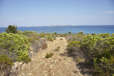 Rocky path that leads to a unique view of the Mediterranean sea in Sardinia.の写真素材