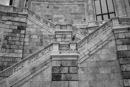 Detail with marble stairs of a historic building in the center of Cagliari in Sardinia taken frontally.の写真素材