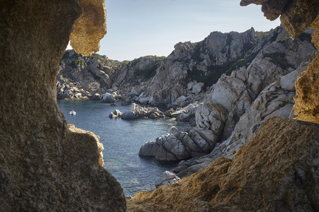 View filtered by granitic rocks of a natural bay in the southern coast of Sardinia during the sunset.の写真素材