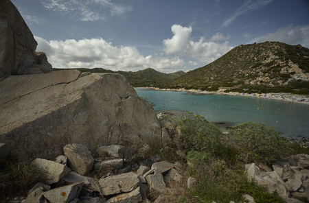 Natural bay filtered by a large rock: typical view of the southern coasts of Sardinia.の写真素材