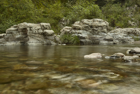 View of a mountain stream with the movement of water cattiurato with a long exposure.の写真素材