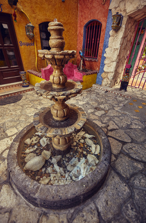 A colorful courtyard with a marble fountain in the foreground: an example of South American architecture.の写真素材