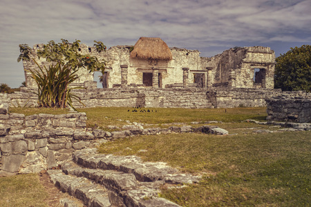 Side view of the remains of a small Mayan temple in the Tulum complex in Mexico taken at sunset.の写真素材