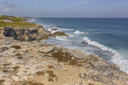 Seascape of rocky coastline with cliff overlooking the sea at Isla Mujeres in Mexicoの写真素材