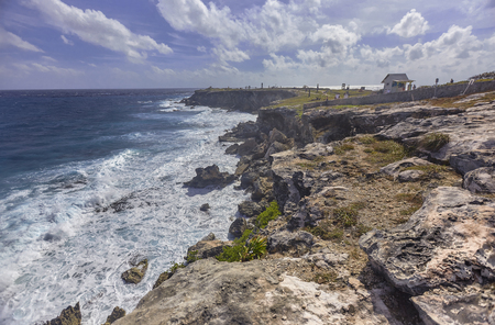 Seascape of rocky coastline with cliff overlooking the sea at Isla Mujeres in Mexicoの写真素材