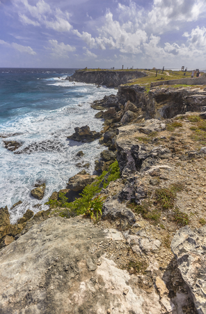 Seascape of rocky coastline with cliff overlooking the sea at Isla Mujeres in Mexicoの写真素材