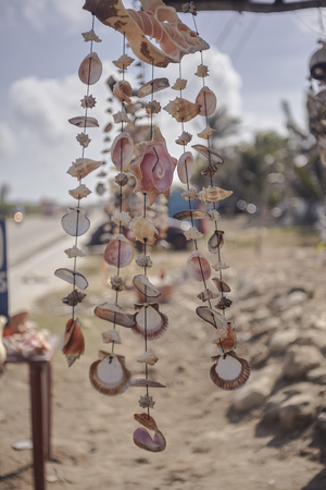 Stand full of dreamcatchers made with shells in a small street of Isla Mujeres in Mexico.の写真素材
