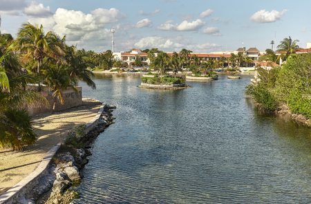 Residential area of Puerto aventuras in mexico, with luxurious private homes overlooking the waterway that leads directly to the sea and the beach.の写真素材