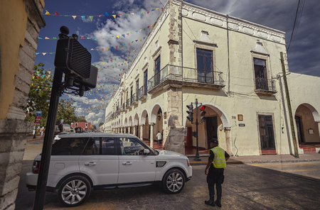 Crossing streets in the center of Valladolid In Mexico, you can see a luxury car that contrasts with the local way of life characterized by a strong classism.のeditorial素材