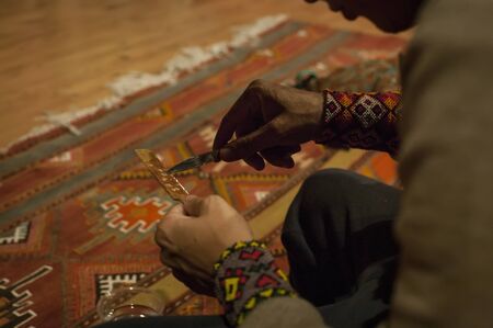 Detail of the shaman's hands as he prepares the KambÃ²: a substance extracted from the glands of a South American frog for its shamanic ceremonyのeditorial素材