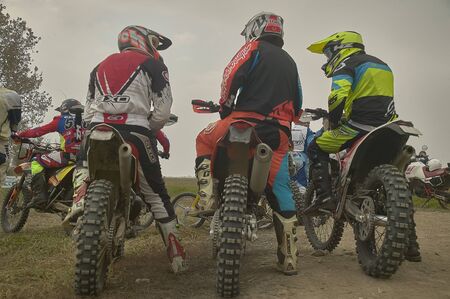 Motocross riders lined up and ready for the start before the raceのeditorial素材