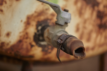Detail of an old rusty faucet corroded by weather and weatherの写真素材