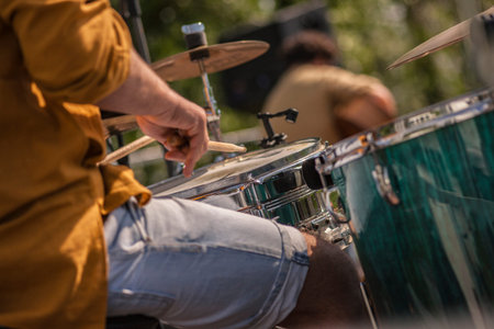 Drummer resumed from behind while making the drums roll at a rock concertの写真素材
