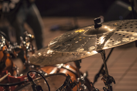Detail of a plate of a drum in the spotlight during a concertの写真素材