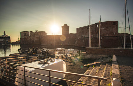 Panoramic view of the port of Livorno with boats moored during sunsetのeditorial素材