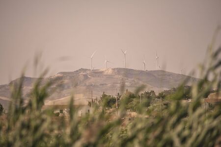 Wind turbines placed on top of a hill in Sicily, Italy, for the production of electric energy...の写真素材