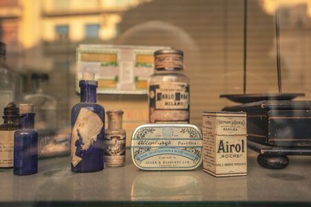 Antique medicine boxes in the window of a pharmacyの写真素材